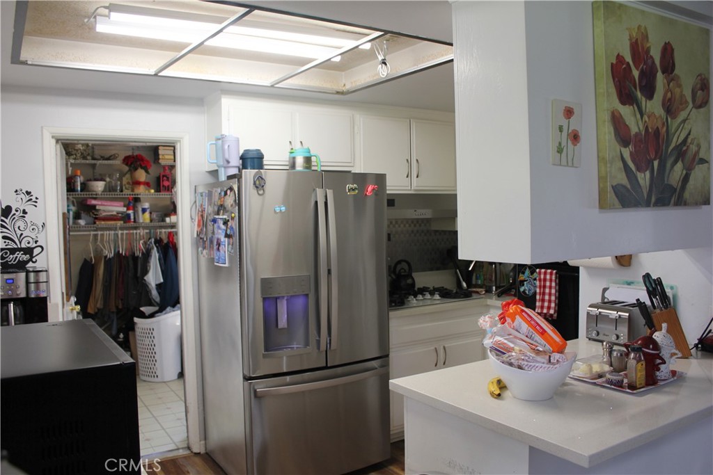 5911 Green Valley Road Riverside, CA 92504 - Photo 5 of 24 a kitchen with refrigerator and washing machine