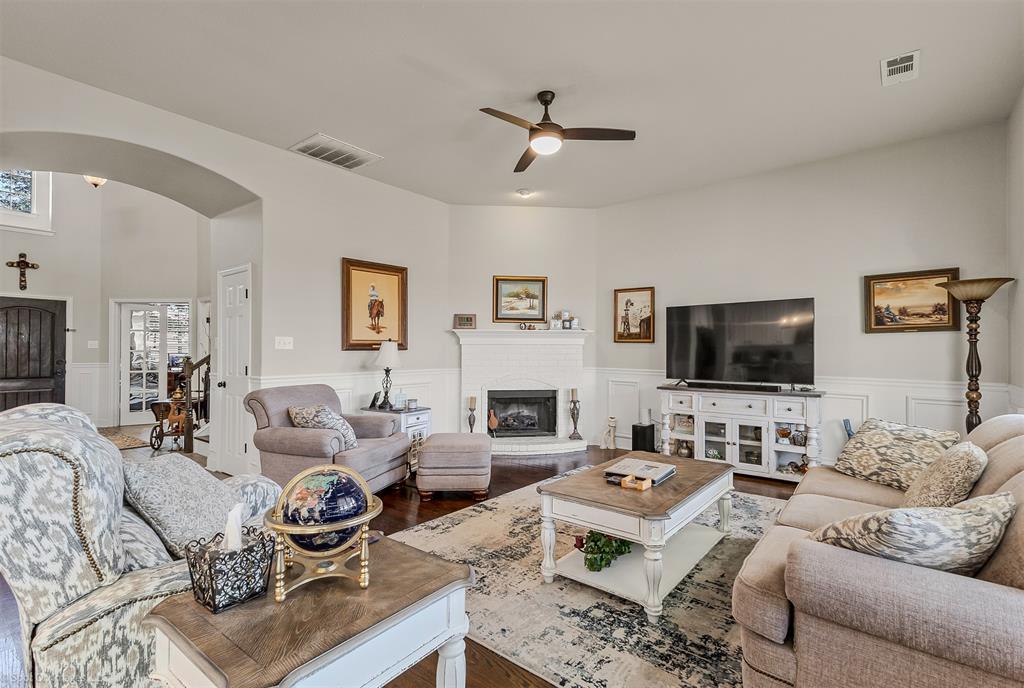 766 Sycamore Trail Forney, TX 75126 - Photo 12 of 37 a living room with furniture flat screen tv and a fireplace