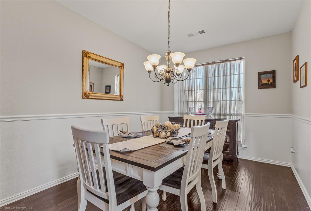766 Sycamore Trail Forney, TX 75126 - Photo 16 of 37 a view of a dining room with furniture a chandelier and wooden floor