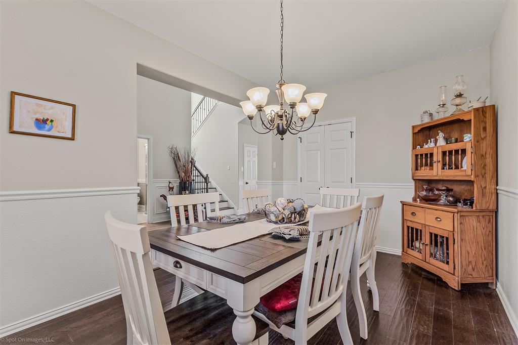 766 Sycamore Trail Forney, TX 75126 - Photo 17 of 37 a view of a dining room with furniture wooden floor and chandelier
