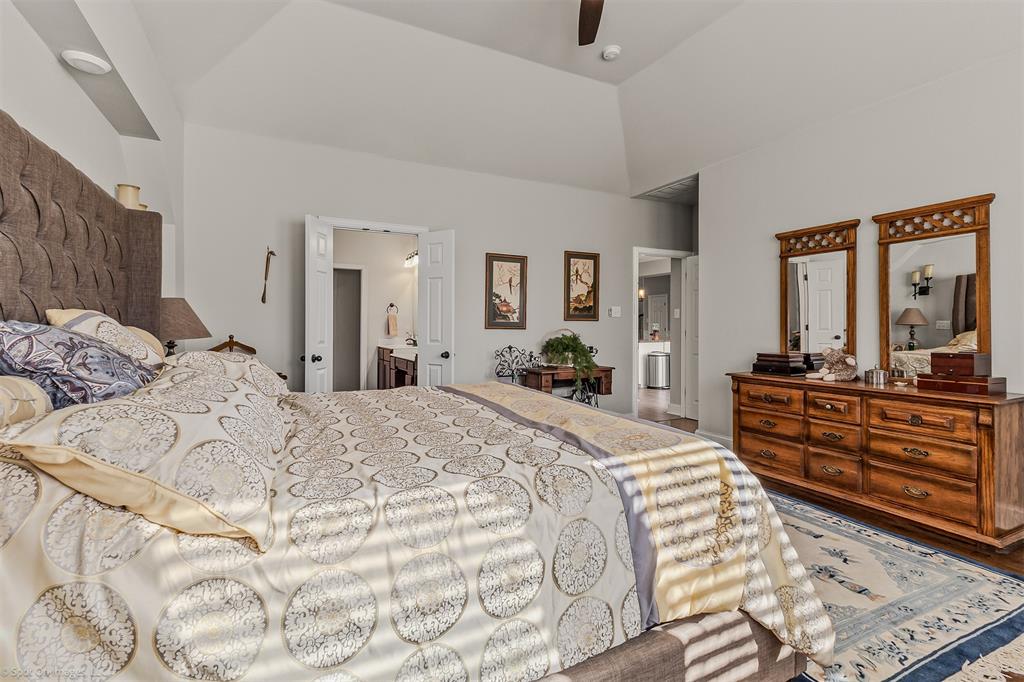 766 Sycamore Trail Forney, TX 75126 - Photo 18 of 37 a bed room with a bed and a large mirror
