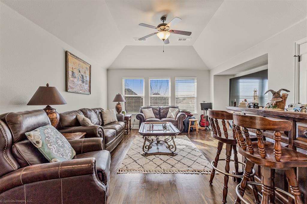766 Sycamore Trail Forney, TX 75126 - Photo 22 of 37 a living room with furniture kitchen view and a chandelier