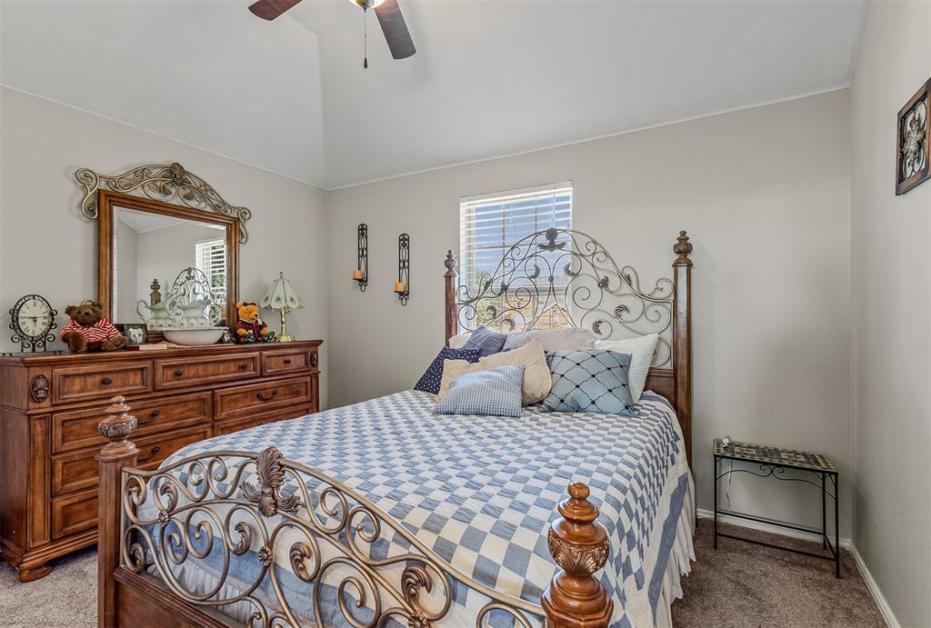 766 Sycamore Trail Forney, TX 75126 - Photo 24 of 37 a bedroom with a bed and a dresser in it