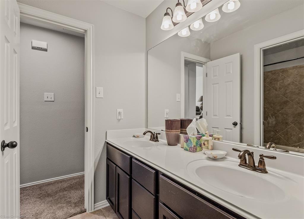 766 Sycamore Trail Forney, TX 75126 - Photo 26 of 37 a bathroom with a sink a large mirror and a light fixture