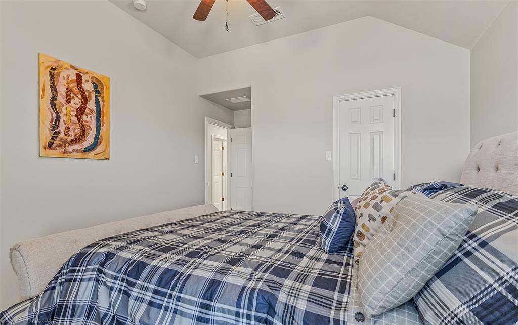 766 Sycamore Trail Forney, TX 75126 - Photo 29 of 37 a bedroom with a bed and a painting on the wall