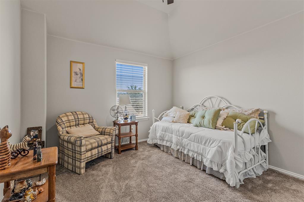 766 Sycamore Trail Forney, TX 75126 - Photo 30 of 37 a bedroom with furniture and a couch