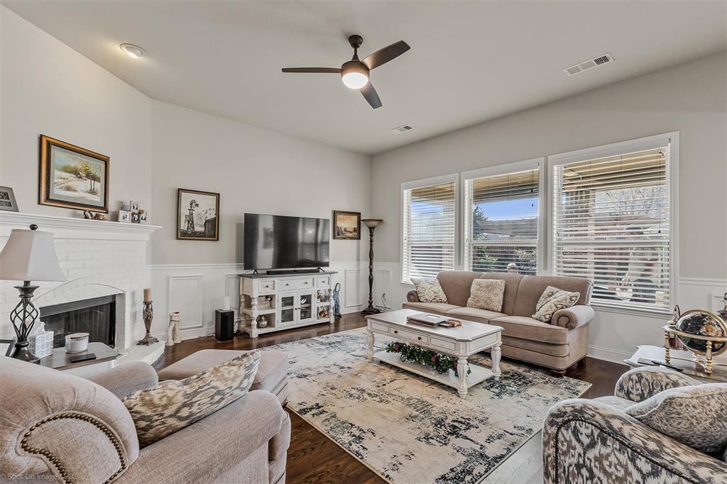766 Sycamore Trail Forney, TX 75126 - Photo 3 of 37 a living room with furniture a fireplace and a flat screen tv