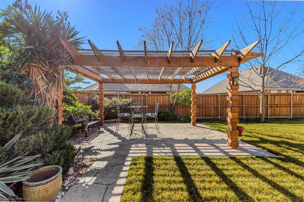 766 Sycamore Trail Forney, TX 75126 - Photo 34 of 37 a view of a backyard with table and chairs with wooden fence
