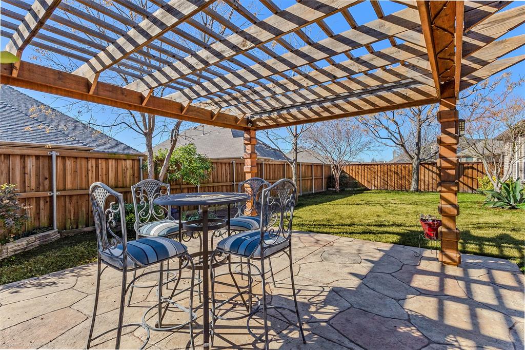 766 Sycamore Trail Forney, TX 75126 - Photo 35 of 37 a view of a patio with table and chairs with wooden floor and plants