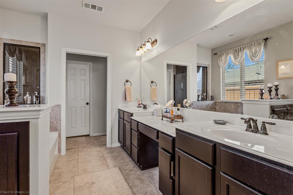 766 Sycamore Trail Forney, TX 75126 - Photo 6 of 37 a spacious bathroom with a double vanity sink a mirror and a shower