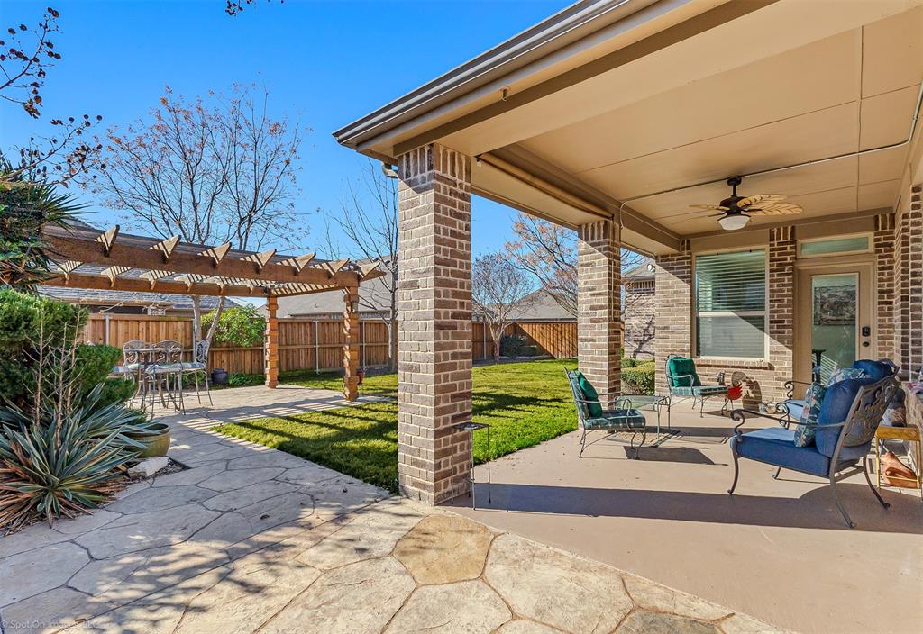 766 Sycamore Trail Forney, TX 75126 - Photo 9 of 37 a view of a backyard with couches chair and floor to ceiling window