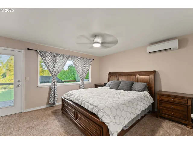 a bedroom with a bed and a large window