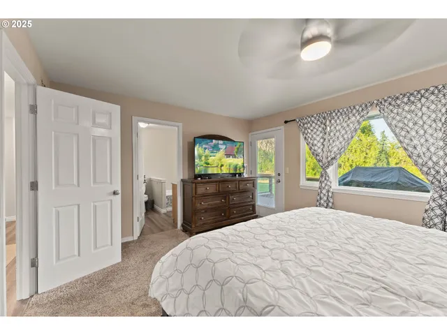 a bedroom with a bed and a large window