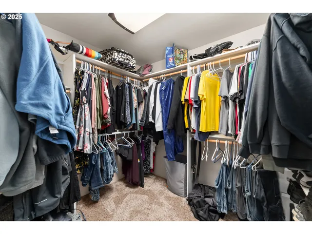 a view of walk in closet with clothes