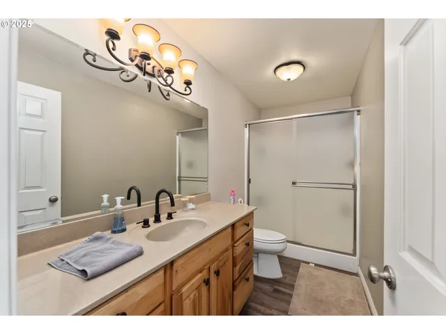 a bathroom with a sink a toilet and a mirror