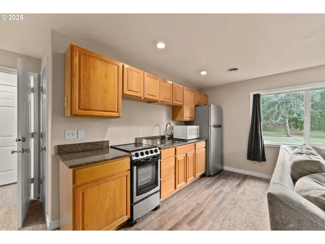 a kitchen with stainless steel appliances granite countertop a stove a sink dishwasher and a refrigerator