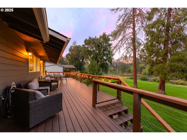 a balcony with wooden floor and outdoor seating