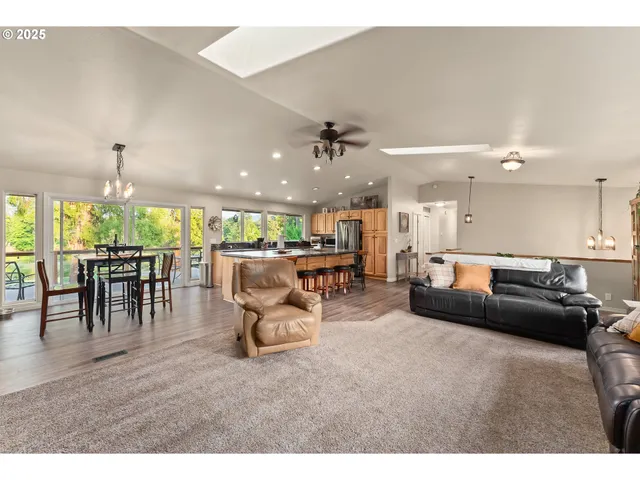 a living room with furniture and a view of kitchen