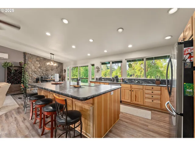 a kitchen with stainless steel appliances granite countertop sink stove and wooden cabinets