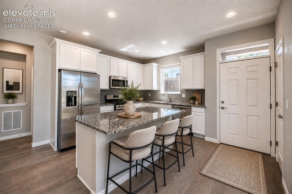 1306 Promontory Bluff View Colorado Springs, CO 80921 - Photo 5 of 39 Virtually staged kitchen