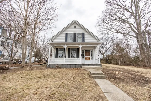 a front view of a house with a yard covered in snow
