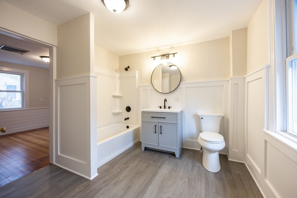 57 Pine Street Milford, MA 01757 - Photo 12 of 29 a bathroom with a sink toilet a mirror and bathtub