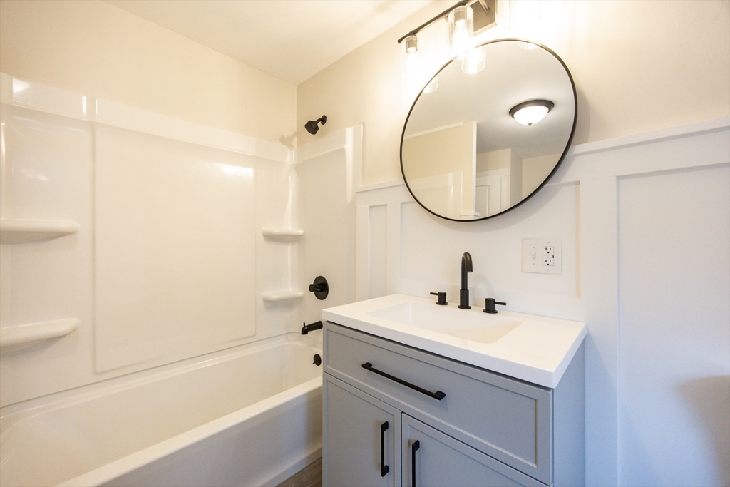 57 Pine Street Milford, MA 01757 - Photo 13 of 29 a bathroom with a sink a toilet and a mirror