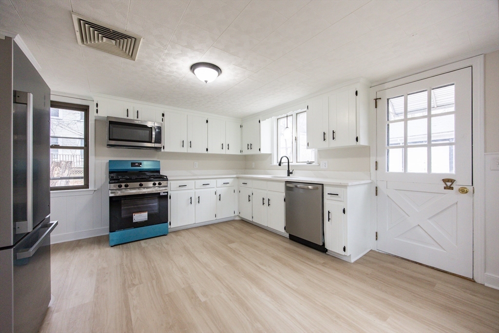 57 Pine Street Milford, MA 01757 - Photo 14 of 29 a kitchen with granite countertop a refrigerator stove top oven and sink