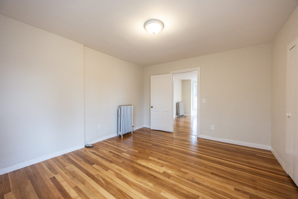 57 Pine Street Milford, MA 01757 - Photo 19 of 29 a view of an empty room with wooden floor