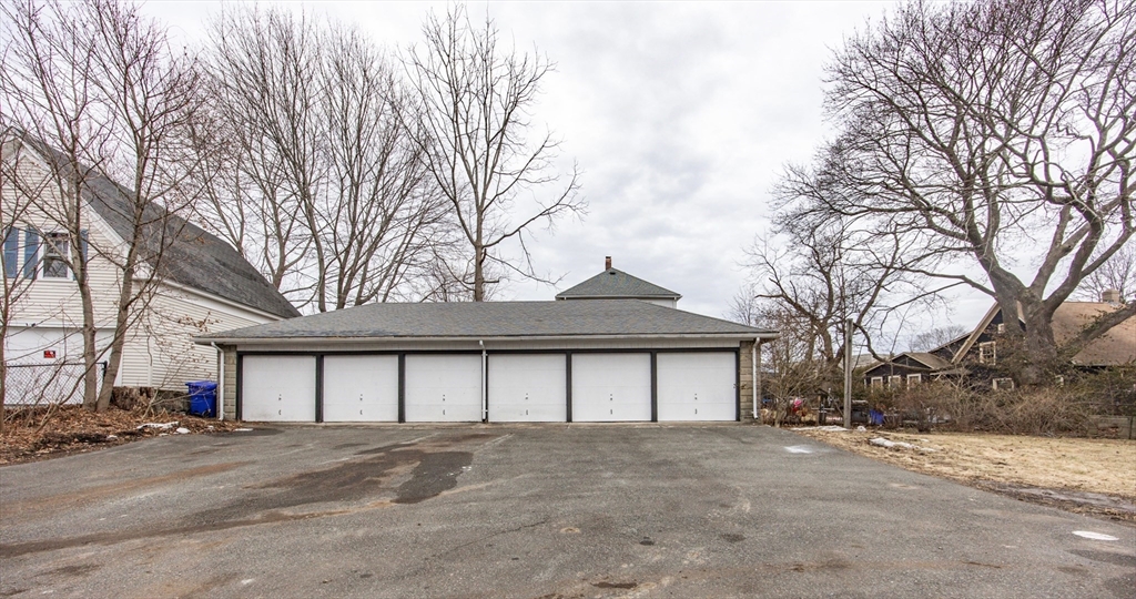 57 Pine Street Milford, MA 01757 - Photo 4 of 29 a view of large house with a large parking space and parking space
