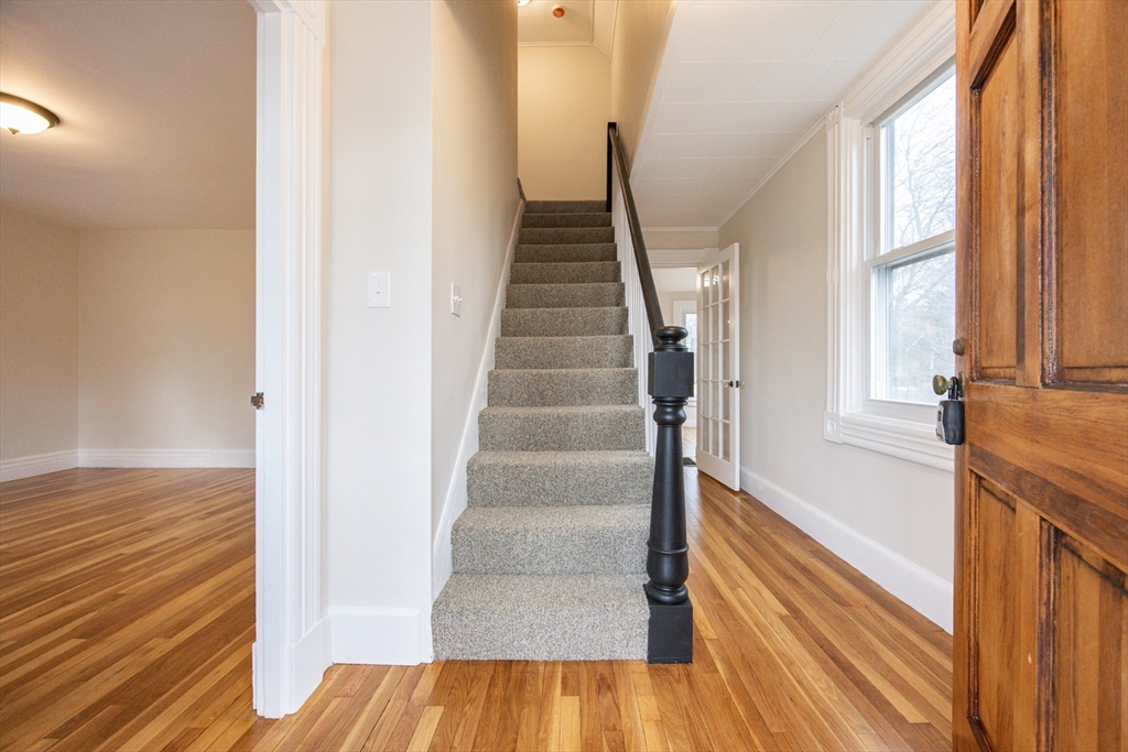 57 Pine Street Milford, MA 01757 - Photo 5 of 29 a view of entryway and hall with wooden floor