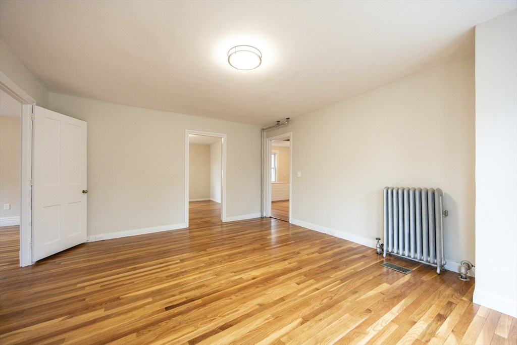 57 Pine Street Milford, MA 01757 - Photo 7 of 29 a view of an empty room with wooden floor