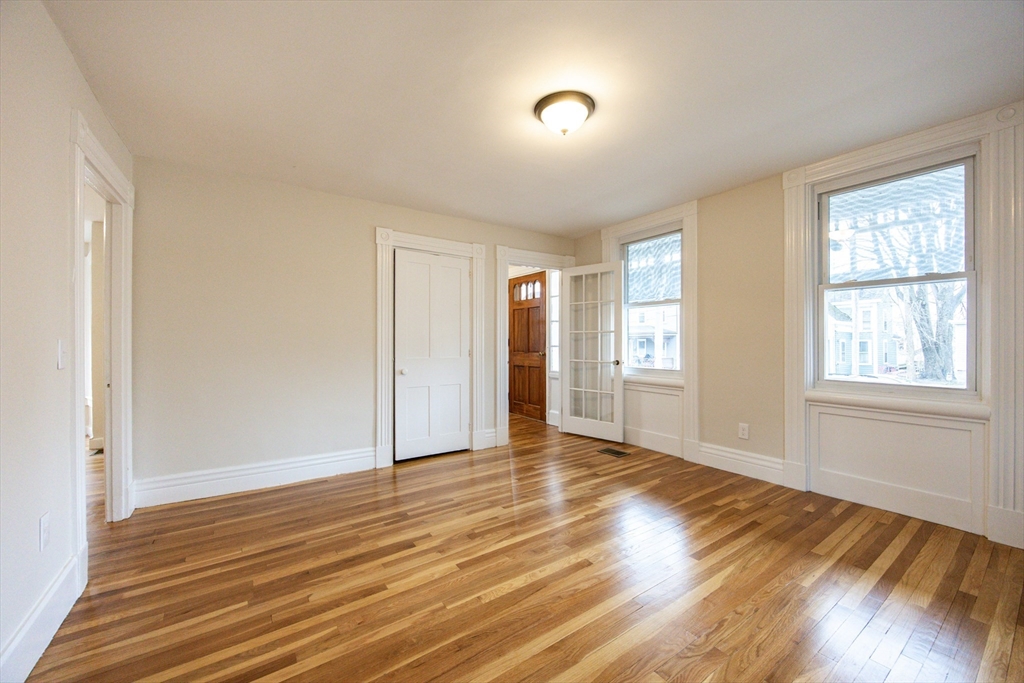57 Pine Street Milford, MA 01757 - Photo 9 of 29 a view of an empty room with wooden floor and a window