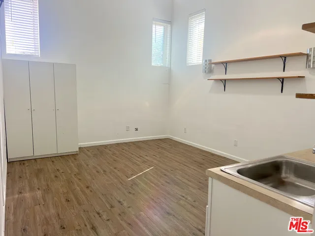 a view of storage and utility room with wooden floor