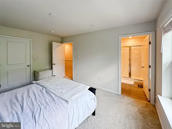 a spacious bathroom with a granite countertop sink and a mirror
