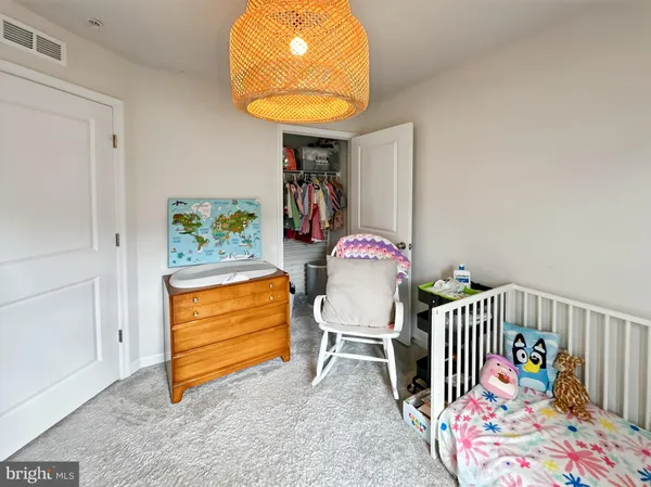 a bed room with a bed and a chair