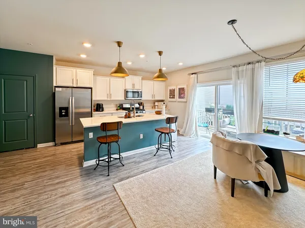 a kitchen with a sink and wooden floor
