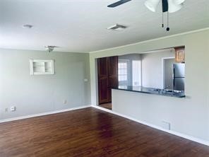 910 Magnolia Street Lake Jackson, TX 77566 - Photo 11 of 12 a view of an empty room with wooden floor and a window