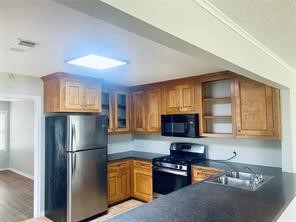 910 Magnolia Street Lake Jackson, TX 77566 - Photo 4 of 12 a kitchen with stainless steel appliances granite countertop a refrigerator and a stove top oven