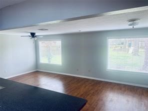 910 Magnolia Street Lake Jackson, TX 77566 - Photo 6 of 12 an empty room with wooden floor and windows