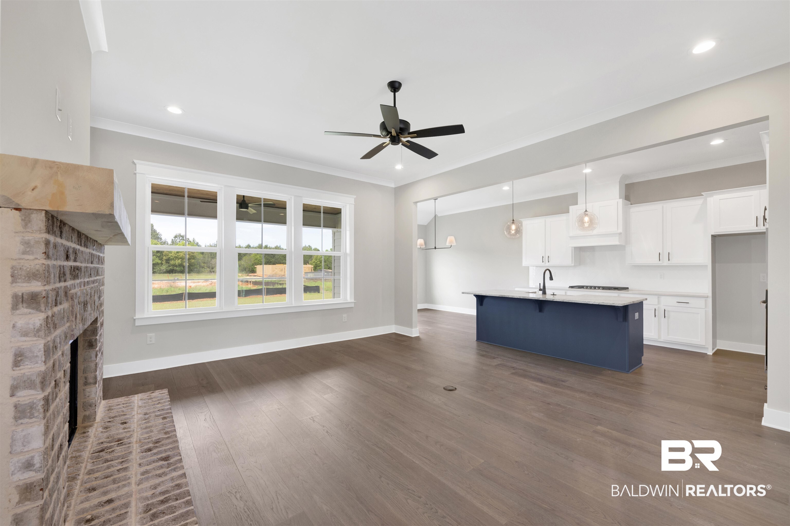 27315 Patch Pl Loop Daphne, AL 36526 - Photo 6 of 43 Unfurnished living room with a fireplace with raised hearth, dark wood finished floors, a ceiling fan, ornamental molding, and recessed lighting