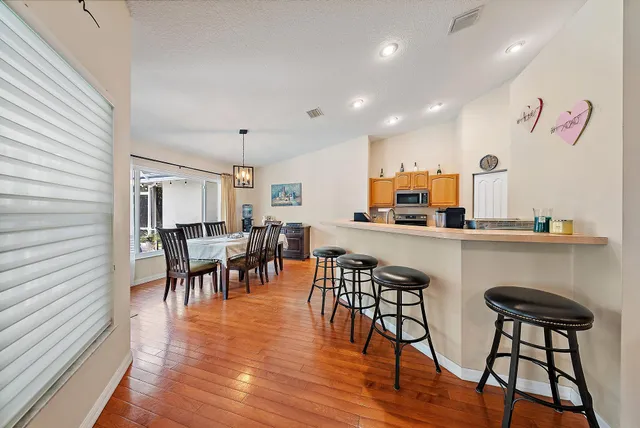 a dining room with furniture and wooden floor