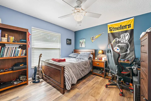 a bedroom with a bed and a chandelier