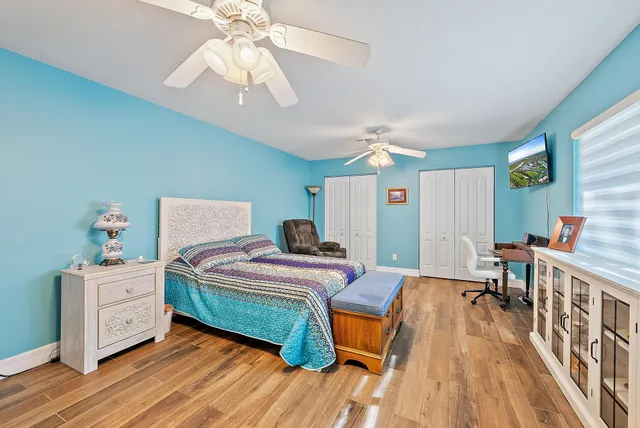 a spacious bedroom with a bed and a dresser