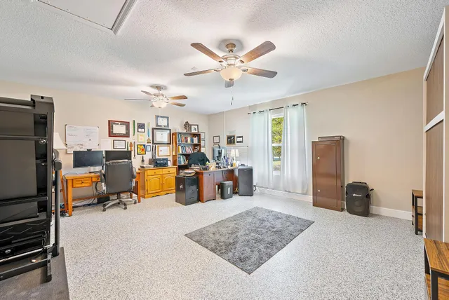 a living room with furniture windows and a flat screen tv