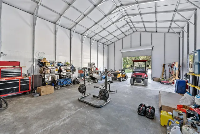 a front view of a house with garden and trees