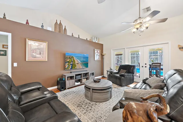 a living room with furniture and a chandelier