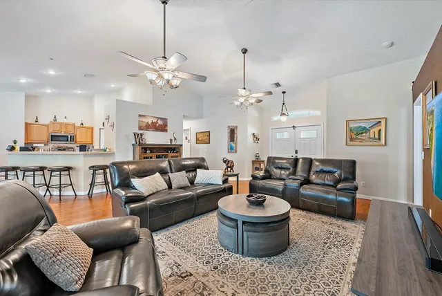 a living room with furniture or couch and a chandelier