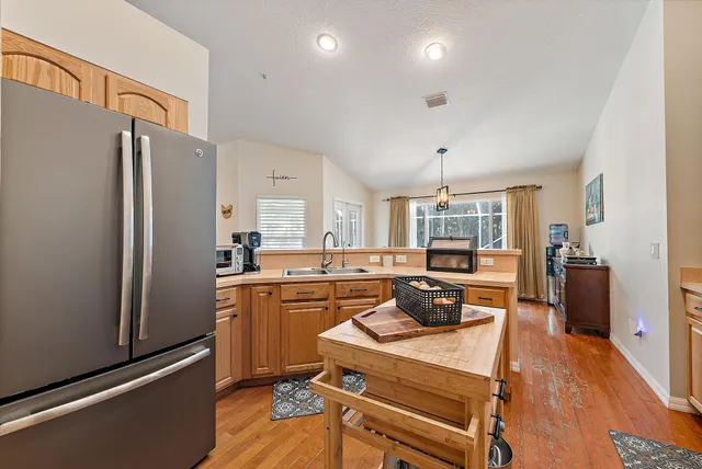 a kitchen with sink refrigerator and stove