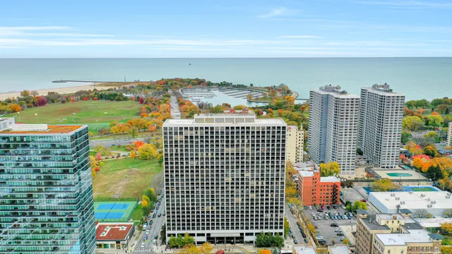 a kitchen with furniture a refrigerator and a stove top oven